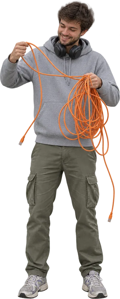 A man untangling a coil of orange cable